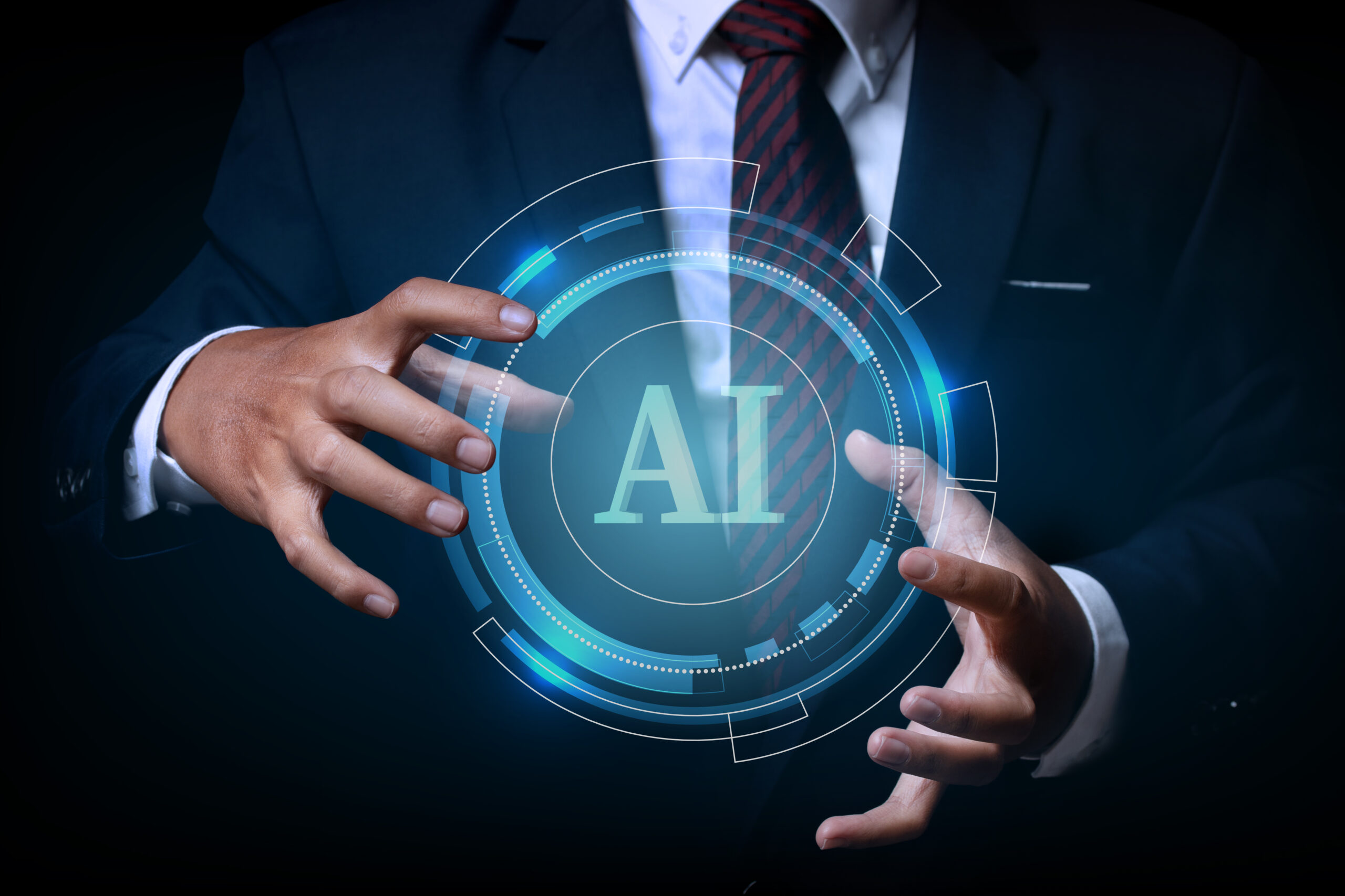 Businessman holding on the AI(Artificial Intelligence) wording with the circle digital hi-tech technology circuit design background. concept innovation.