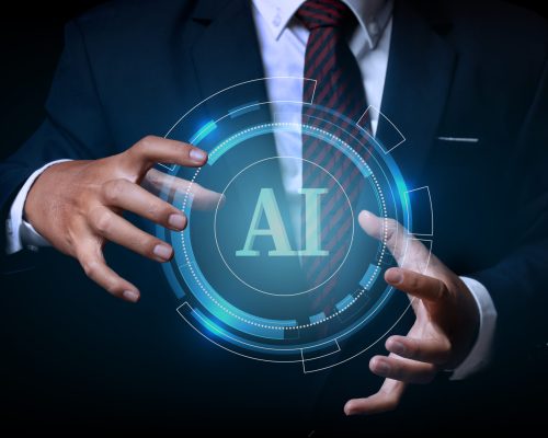 Businessman holding on the AI(Artificial Intelligence) wording with the circle digital hi-tech technology circuit design background. concept innovation.