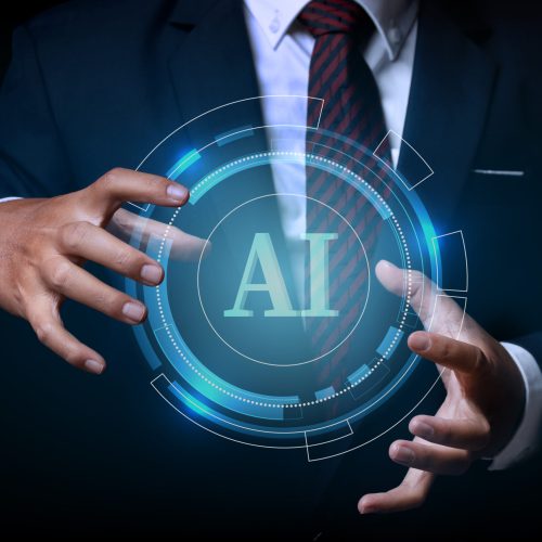 Businessman holding on the AI(Artificial Intelligence) wording with the circle digital hi-tech technology circuit design background. concept innovation.